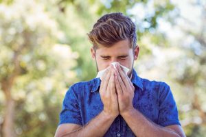 Blogs 3 Man with a cold sneezing into a tissue